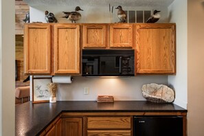 Fridge, coffee/tea maker, cookware/dishes/utensils, dining tables