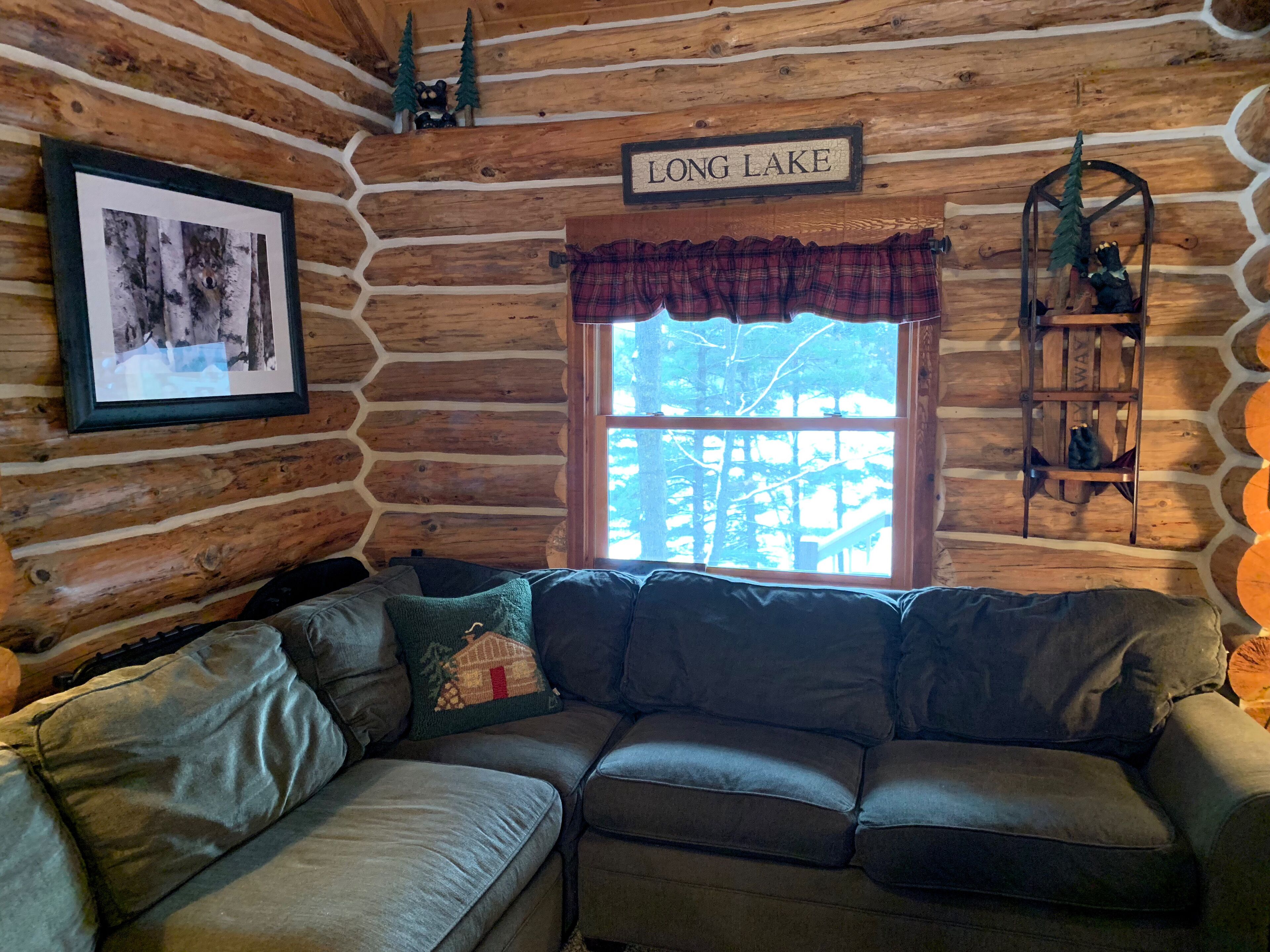 Log cabin on 19 mile Long Lake, large screen porch + dock, within mature pines