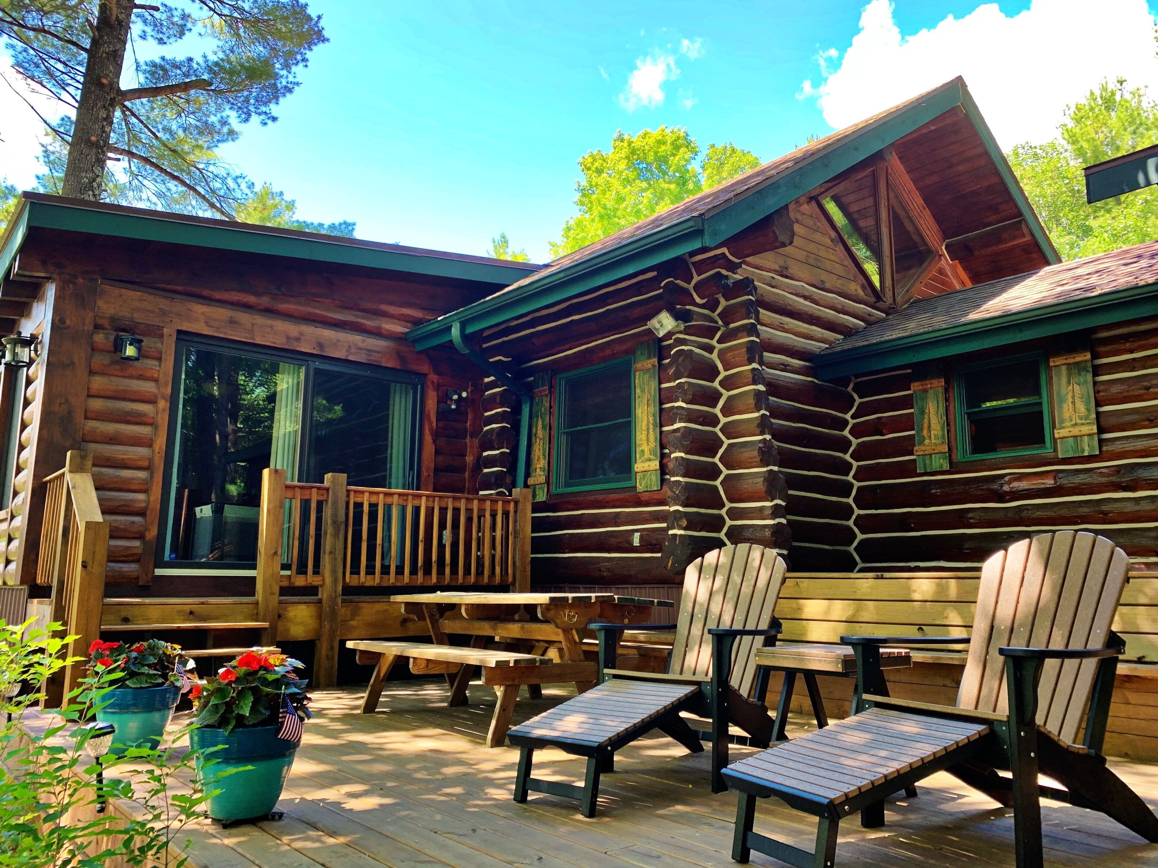 Log cabin on 19 mile Long Lake, large screen porch + dock, within mature pines