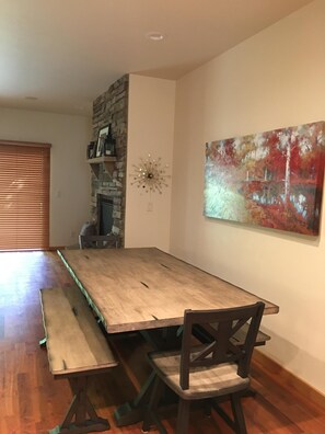A dining area with a long wooden table, benches, and chairs. - This beautiful, spacious condo is located right off Main Street in Ouray. (Ouray)