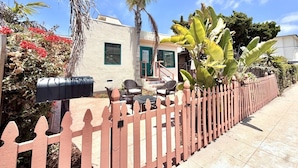 A house with a patio, outdoor furniture, a mailbox, and a picket fence. - JULY 2026 NEW REMODEL... Mermaid`s Cove, Nestled between Beach and Bay! (San Diego)