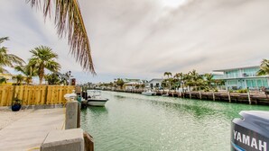 A marina with boats, a wooden dock, and a building with a balcony. - Doc's Holiday updated 2bed/2bath half duplex with Cabana Club (Key Colony Beach)