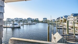 A marina with docked boats and waterfront houses. - Marina view one bedroom cottage close to amenities on BHI. Walking distance to the NC lighthouse (Bald Head Island)