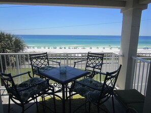 A balcony with a table and chairs overlooking a beach. - Pets (dogs)Welcome *  Sea 4 Miles*  Sea 4 Yourself* Maravilla 2301 (Destin)