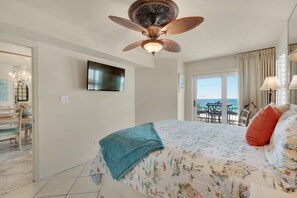 A bedroom with a bed, a ceiling fan, a TV, and a view of the sea through a door. - Pets (dogs)Welcome *  Sea 4 Miles*  Sea 4 Yourself* Maravilla 2301 (Destin)