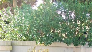A wall with the text "Sugar Beach" in gold lettering. - Beach Rendezvous-Beachside Complex with a Pool (Navarre)