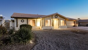 A single-story house with a tiled roof, a front porch, and a garage. - Spacious 3+3 w/ Pool & Game room, 5mins from Lake (Lake Havasu City)