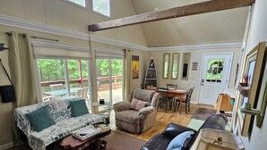 A spacious living room with a large window, a fireplace, and a dining area.