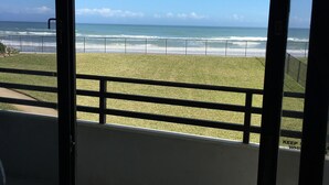 A balcony with a view of the beach and ocean. - Spacious Oceanfront 1st Floor 2 BR/2 BA Condo (Daytona Beach)