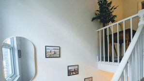 A staircase with white railings and a mirror on the wall. - Luxury 4/5 bed 2 bath Victorian London home (London)