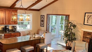 A spacious living area with a kitchen, a dining area, and a seating area with a sofa and chairs. - Flat Lot, Views! Waterslide, Firepit, Kayaks, Pickleball, Pingpong, Tennis, WiFi (Moneta)