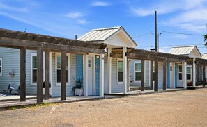 A row of single-story buildings with a covered walkway.