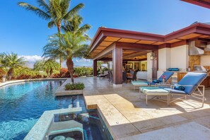 A pool area with lounge chairs, a hot tub, and a covered patio with a view of the ocean. - Champion Ridge Home: Luxe w/ Private Pool,Spa,AC & Ocean/Mountain View (Kamuela)