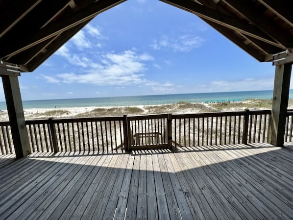 A wooden deck with a view of the beach and ocean. - Ft Morgan, Cabana Beach Gulf Front, large deck, sleeps 10, 12 with foldout sofa (Gulf Shores)