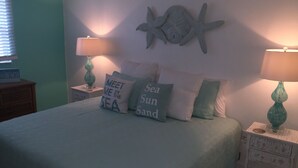 A bedroom with a bed, two nightstands, and decorative pillows. - STEPS TO BEACH & STEPS TO BAY & TO WATCH DOLPHINS! 3 MIN WALK TO RESTAURANTS (Englewood)