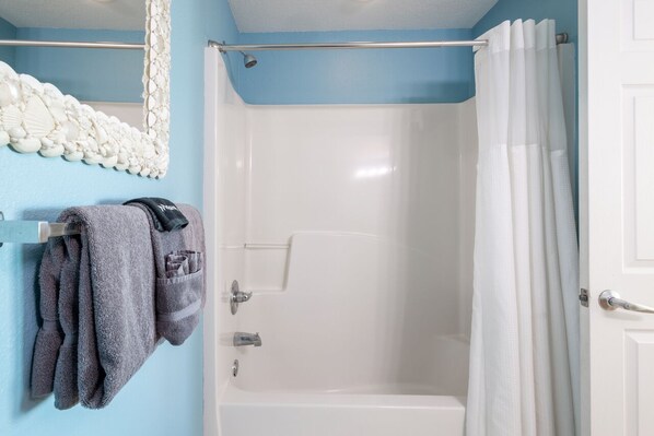 A bathroom with a bathtub, a shower, and a towel rack with towels. - #106 -' Beauty and the Beach'- Gulf Front 4th floor/2BD 2BA/Large Balcony. (Gulf Shores)