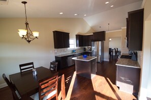 Enjoy cooking in this well-equipped kitchen with a central island, dining area, and modern appliances.