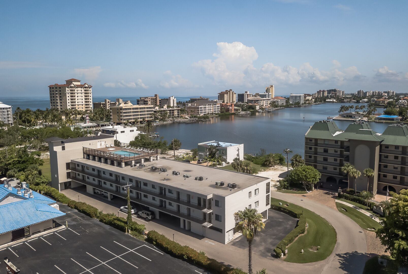 A hotel with a rooftop pool, a marina, and a view of the city skyline.