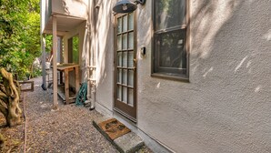 A building with a porch, a door, and a window.
