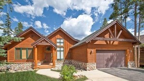 A two-story log cabin with a stone foundation, a front porch, and a garage. - Luxury Home, Family Friendly, 4900 Sq Foot, 6 BR Ski in/Out! (Breckenridge)