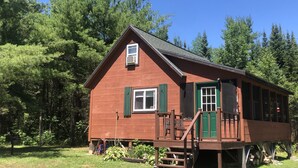 A wooden cabin with a porch, a small window, and a door. - Secluded / Private Maine Lake Retreat,
WIR SPRECHEN DEUTSCH , (Burnham)