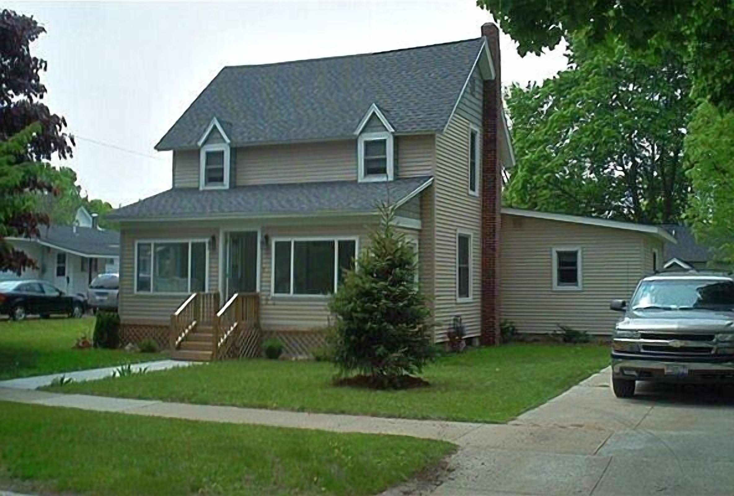 House with enclosed front porch, nice back yard and rear deck.