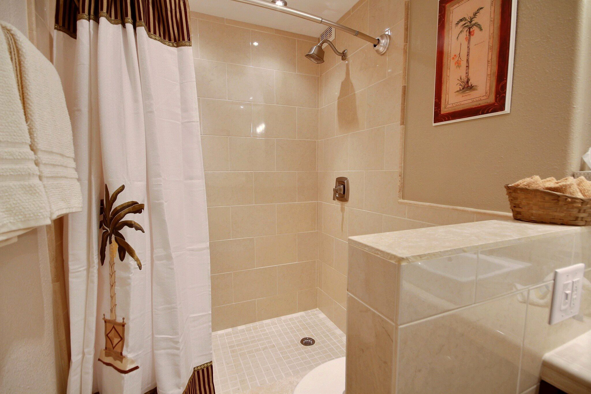 A bathroom with a shower, a toilet, and a sink.