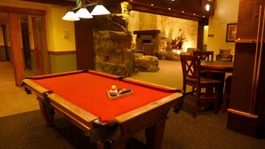 A pool table with balls, a fireplace, and seating in a room with stone walls. - Family Friendly in River Run. Heated pool & slide, steps from gondola and shops (Keystone)