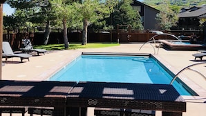 Ein Swimmingpool mit Liegestühlen und einer Pergola.