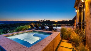 A hot tub with lounge chairs, a pool, and a view of the landscape. - Farm Stay Villa on 55 Acres // Pool, Hot Tub & Complimentary Wine Tasting (Healdsburg)