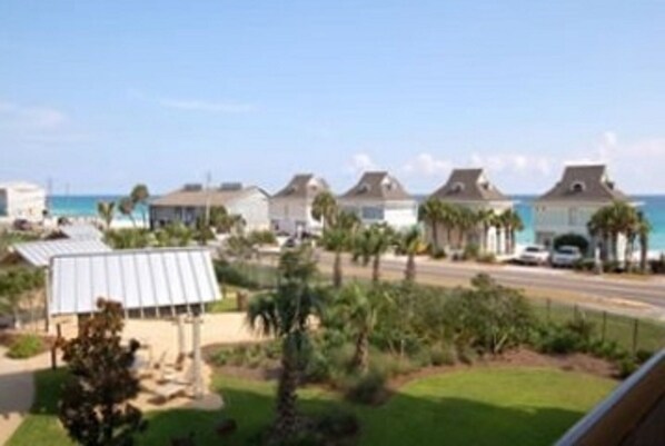 A coastal residential area with houses, a beach, and a clear sky. - BR-313--PREPAID BEACH SERVICE- NEW LR FURNITURE-LOVELY VIEWS-OWNER MANAGED (Miramar Beach)