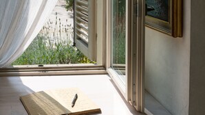 A room with a window, a table with a notebook and pen, and a chair. - Casa Matilde: the coziest nest in downtown Torino (Torino)