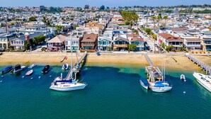 A coastal town with a marina, houses, and a beach.