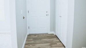 A hallway with a wooden floor and white walls. - Beautiful Remodeled Home by Ski Resorts & Shopping (Sandy)