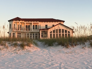 A large, multi-story beachfront property with a prominent balcony and a covered area. - Gulf Front, 3 Gulf Front Master Suites, Heated Balcony Pool  (Navarre)