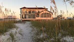 A beachfront property with a large building featuring multiple balconies and a covered walkway. - Gulf Front, 3 Gulf Front Master Suites, Heated Balcony Pool  (Navarre)