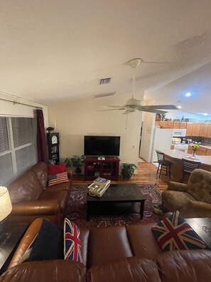 Open layout of the comfortable living room, kitchen and dining area.