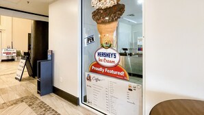 A Hershey's ice cream advertisement on a glass wall in a hotel lobby.