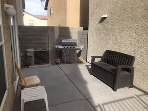 Enjoy al fresco dining on the patio, where a barbecue grill and comfortable seating await.