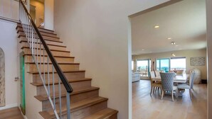 A staircase leading to a dining area with a view.