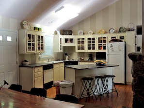 Kitchen with sink, stove, refrigerator, and central island.