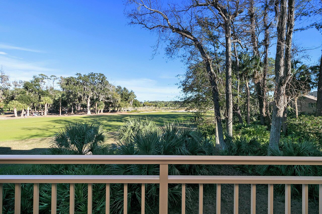A golf course with a wooden deck in the foreground.