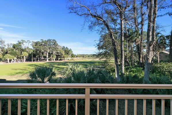 A golf course with a wooden deck in the foreground. - Stunning Condo in Plantation Club with Views of the Golf Course and On-site Amenities! (Hilton Head)