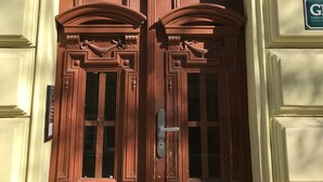 A brown double door with intricate carvings and a number "801" above it.