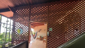 A covered outdoor area with a hammock, a wooden bench, and a door marked "15 Down". - Gorgeous Views of Pacific and Rainforest (Manuel Antomio)