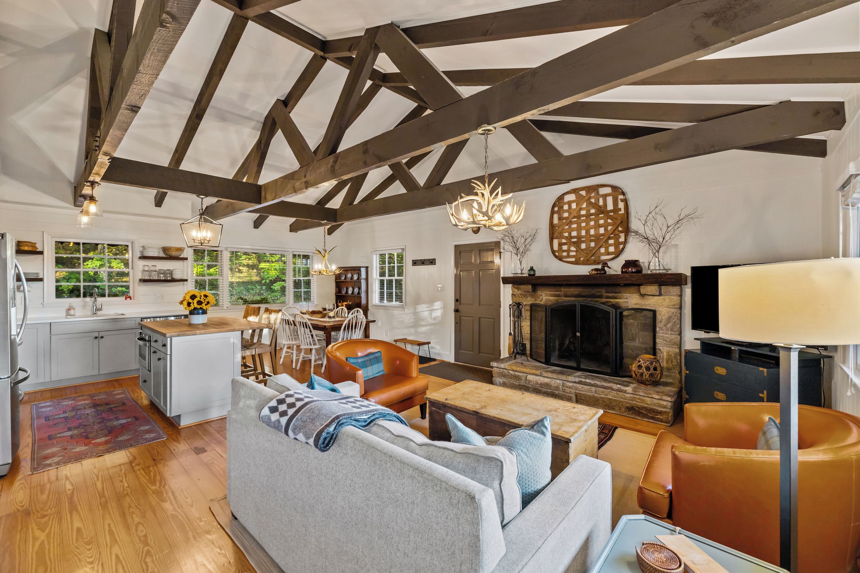 Scandinavian-inspired design meets mountain charm, with soaring wood-beamed ceilings, a stone fireplace, and thoughtfully curated interiors.