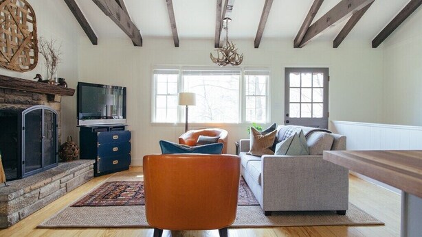 A living room with a fireplace, a television, and a sofa. - The Dala House | Scandinavian Retreat in Blowing Rock (Blowing Rock)