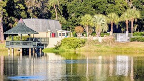 A gazebo over a pond with a house in the background. - Shipyard: 271 Evian Island Villa-Relaxing Setting Weekly Rates Discounted (Hilton Head Island)
