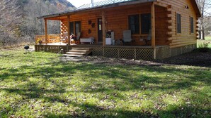 A wooden cabin with a porch, a covered deck, and a mountain backdrop. - Simple.  Rustic.  Luxury. (Monterey)