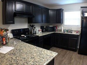 Fridge, microwave, oven, stovetop - Cozy, Chic Townhouse / 515B (Lake Charles)